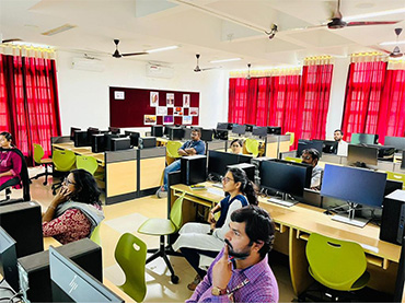 Two men in bicycle jerseys sitting outside at table having coffee